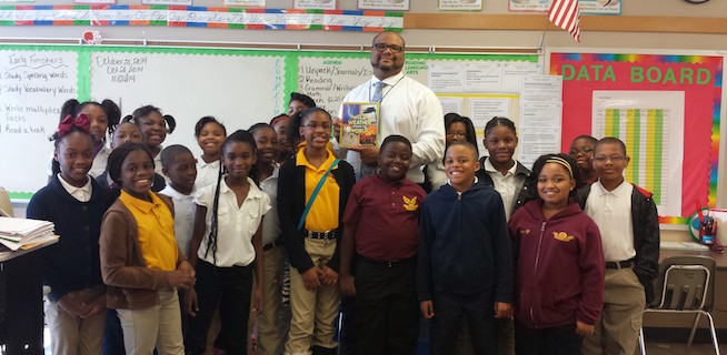 Educator Tim Wear in a classroom surrounded by students