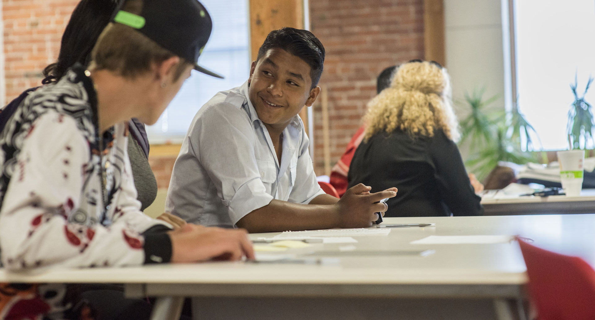 Students at a work table talking