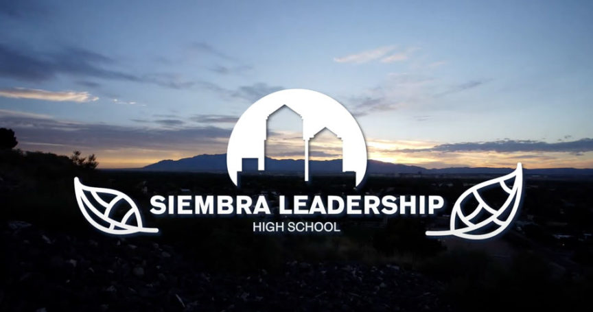 Siembra Leadership High School logo superimposed on the Sandia Mountains at sunrise
