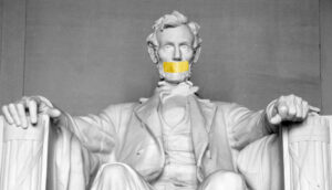 A yellow patch covers the mouth of a statue of Abraham Lincoln.