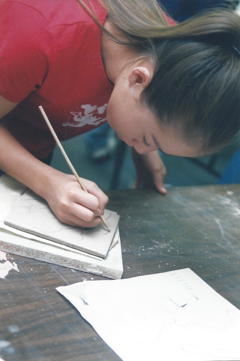 Student working on art piece in classroom