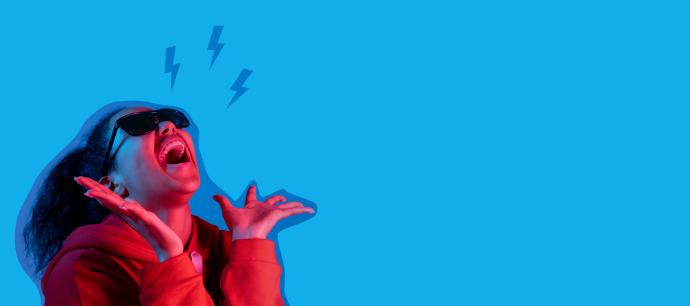 Singing woman on blue studio background in magazine style.