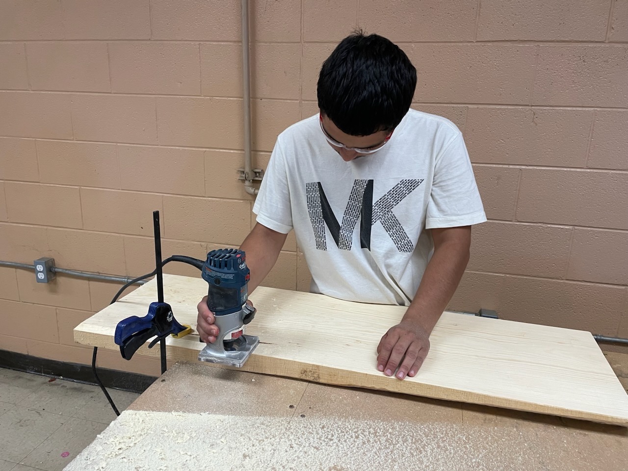 Student using a wood router.